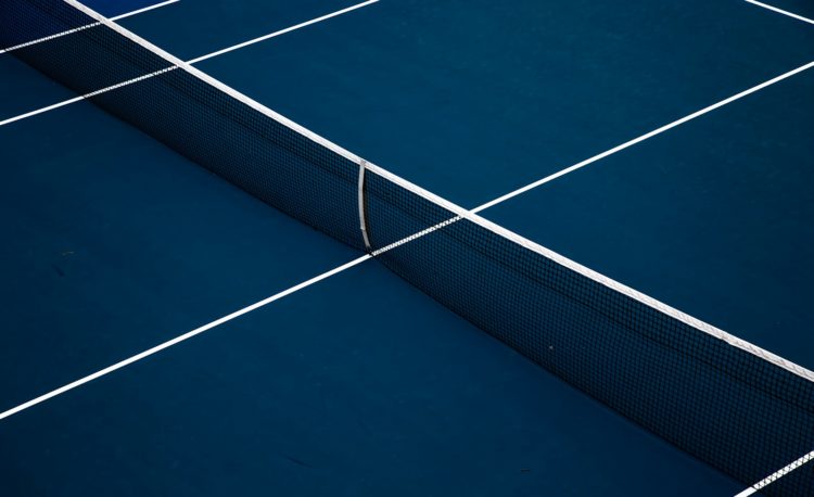 a blue tennis court with a white line on it